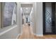 Bright hallway with light hardwood floors and fresh, neutral colored walls at 5829 W Alyssa Ln, Phoenix, AZ 85083