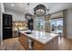 Expansive kitchen featuring an island, modern appliances, custom cabinetry, and a view of the outdoor pool at 5829 W Alyssa Ln, Phoenix, AZ 85083