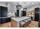 Modern kitchen with a large island, stainless steel appliances, and stylish pendant lighting at 5829 W Alyssa Ln, Phoenix, AZ 85083