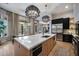 Spacious kitchen with an island, modern appliances, sleek cabinetry, and views of the outdoor dining and pool area at 5829 W Alyssa Ln, Phoenix, AZ 85083
