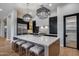 Modern kitchen with oversized island, bar seating, and stainless-steel appliances at 5829 W Alyssa Ln, Phoenix, AZ 85083