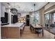 Open kitchen and dining area with modern lighting, large island, and outdoor access at 5829 W Alyssa Ln, Phoenix, AZ 85083