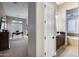 Open view into an office space that includes a large desk, windows with shutters, and a Primary bath area at 5829 W Alyssa Ln, Phoenix, AZ 85083