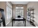 Inviting office with shutters, a large desk, and built-in shelving filled with decor at 5829 W Alyssa Ln, Phoenix, AZ 85083