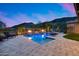 Inviting backyard oasis features a sparkling pool, fire bowls, and mountain views at 5829 W Alyssa Ln, Phoenix, AZ 85083