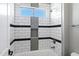 Bright bathroom featuring a tiled shower and bathtub combination with a window for natural light at 60 W Tonto Dr, Chandler, AZ 85248