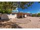 Backyard featuring rock landscaping and a covered patio, perfect for entertaining at 6305 E Adobe Rd, Mesa, AZ 85205