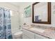 Charming bathroom featuring a vanity with granite counters and tiled shower/tub combo at 6305 E Adobe Rd, Mesa, AZ 85205