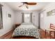 Bright bedroom featuring a ceiling fan, one window, and hardwood floors at 6305 E Adobe Rd, Mesa, AZ 85205
