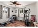 Bedroom includes exercise equipment, ceiling fan, and bright natural light at 6305 E Adobe Rd, Mesa, AZ 85205