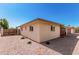 Tan ranch home with desert landscaping and block fence at 6305 E Adobe Rd, Mesa, AZ 85205