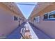 Inviting outdoor hallway with seating, connecting residents to community activity rooms in a well-lit setting at 6305 E Adobe Rd, Mesa, AZ 85205