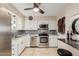 Bright kitchen featuring white cabinets, stainless appliances, and tile floors at 6305 E Adobe Rd, Mesa, AZ 85205