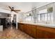 A bright utility room featuring lots of storage cabinetry and an adjoining exercise area at 6305 E Adobe Rd, Mesa, AZ 85205