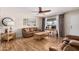 The open living room has wood floors, neutral walls, and a ceiling fan at 6305 E Adobe Rd, Mesa, AZ 85205