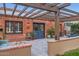 Inviting covered patio with brick accents, outdoor seating, and a pergola offering a cozy space at 6314 N 14Th Pl, Phoenix, AZ 85014