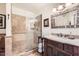 Bathroom with glass enclosed shower, ornate mirror, and detailed vanity with drawers at 6314 N 14Th Pl, Phoenix, AZ 85014