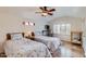 Cozy bedroom with two twin beds, ceiling fan, and a desk area at 6314 N 14Th Pl, Phoenix, AZ 85014
