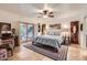 Comfortable main bedroom with stone tile flooring, ceiling fan and access to outdoor patio at 6314 N 14Th Pl, Phoenix, AZ 85014