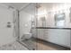 Bathroom features white tiled walls, dual sinks, and a glass enclosed shower for a refreshing and clean look at 6502 N Central Ave # A103, Phoenix, AZ 85012