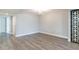 This bedroom features sleek gray laminate flooring, modern white trim, and a decorative accent rug at 6502 N Central Ave # A103, Phoenix, AZ 85012