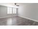 Bedroom with neutral walls, laminate floors, a ceiling fan, and shuttered windows offering a cozy retreat at 6502 N Central Ave # A103, Phoenix, AZ 85012