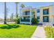 Inviting two-story condo with a well-manicured lawn and mature palm trees, creating a tranquil outdoor space at 6502 N Central Ave # A103, Phoenix, AZ 85012