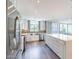 Modern kitchen featuring stainless steel appliances, sleek white cabinetry, and a large central island at 6502 N Central Ave # A103, Phoenix, AZ 85012
