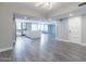 Open-concept living area featuring laminate floors, recessed lighting, and a modern kitchen with a large island at 6502 N Central Ave # A103, Phoenix, AZ 85012