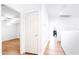 Bright hallway with wood floors and white doors leading to various rooms in the home at 696 W Del Rio St, Gilbert, AZ 85233