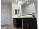 Elegant bathroom featuring dual sinks, dark wood cabinetry and ample counter space at 7694 W Saddlehorn Rd, Peoria, AZ 85383