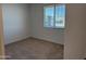 Bright, carpeted bedroom with a window providing natural light and a view of the outdoors at 7694 W Saddlehorn Rd, Peoria, AZ 85383