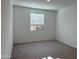 Spacious, carpeted bedroom with ample natural light from the window, offering a comfortable living space at 7694 W Saddlehorn Rd, Peoria, AZ 85383