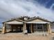 New home in progress featuring wood framing and architectural details under a partly cloudy sky at 7694 W Saddlehorn Rd, Peoria, AZ 85383