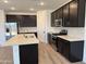 Spacious kitchen boasts a large island, stainless appliances, and stylish backsplash at 7694 W Saddlehorn Rd, Peoria, AZ 85383