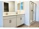 Bathroom featuring double sinks, white cabinetry, and a glass shower enclosure at 7701 W Avenida Del Rey --, Peoria, AZ 85383