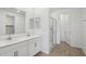 Bright bathroom with double sinks, a large mirror, and a glass-enclosed shower stall at 7701 W Avenida Del Rey --, Peoria, AZ 85383