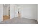 A carpeted bedroom leads to other rooms, including a glimpse of the kitchen at 7701 W Avenida Del Rey --, Peoria, AZ 85383