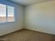 Bright bedroom featuring a large window and neutral carpet at 7701 W Avenida Del Rey --, Peoria, AZ 85383