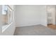 A cozy bedroom features plush carpet, a window, and a view into the bathroom at 7701 W Avenida Del Rey --, Peoria, AZ 85383