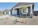 Charming home featuring a two-car garage and a xeriscaped front yard with young tree at 7701 W Avenida Del Rey --, Peoria, AZ 85383