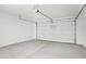 Spacious two car garage with overhead door, storage rack, and bright lighting at 7701 W Avenida Del Rey --, Peoria, AZ 85383