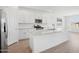 Stylish kitchen boasts white cabinets, a spacious island, stainless steel appliances, and backsplash at 7701 W Avenida Del Rey --, Peoria, AZ 85383