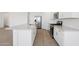Modern kitchen features a large island, stainless steel appliances, and white cabinetry at 7701 W Avenida Del Rey --, Peoria, AZ 85383
