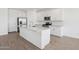 Modern kitchen features a large island, stainless steel appliances, and white cabinetry at 7701 W Avenida Del Rey --, Peoria, AZ 85383