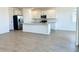 Bright kitchen with stainless steel appliances, a large island, and modern cabinetry at 7701 W Avenida Del Rey --, Peoria, AZ 85383