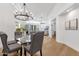 Bright dining room features modern chandelier, glass table, and comfortable seating at 7787 E Via Casta --, Scottsdale, AZ 85258