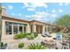 Beautiful backyard showcasing a fire pit, lounge chairs, lush plants and direct access to the home at 7915 E Stonecliff Cir, Mesa, AZ 85207