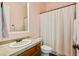 Cozy bathroom featuring a single sink vanity, toilet, and shower with white accents at 7915 E Stonecliff Cir, Mesa, AZ 85207