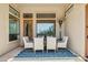 Covered patio dining area featuring a stylish table, chairs, and a scenic view from large windows at 7915 E Stonecliff Cir, Mesa, AZ 85207